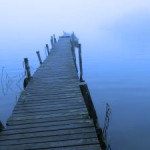 a bridge into a lake in blue
